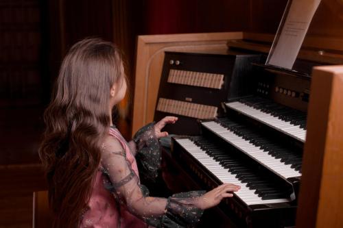 Little girl playing a pipe organ